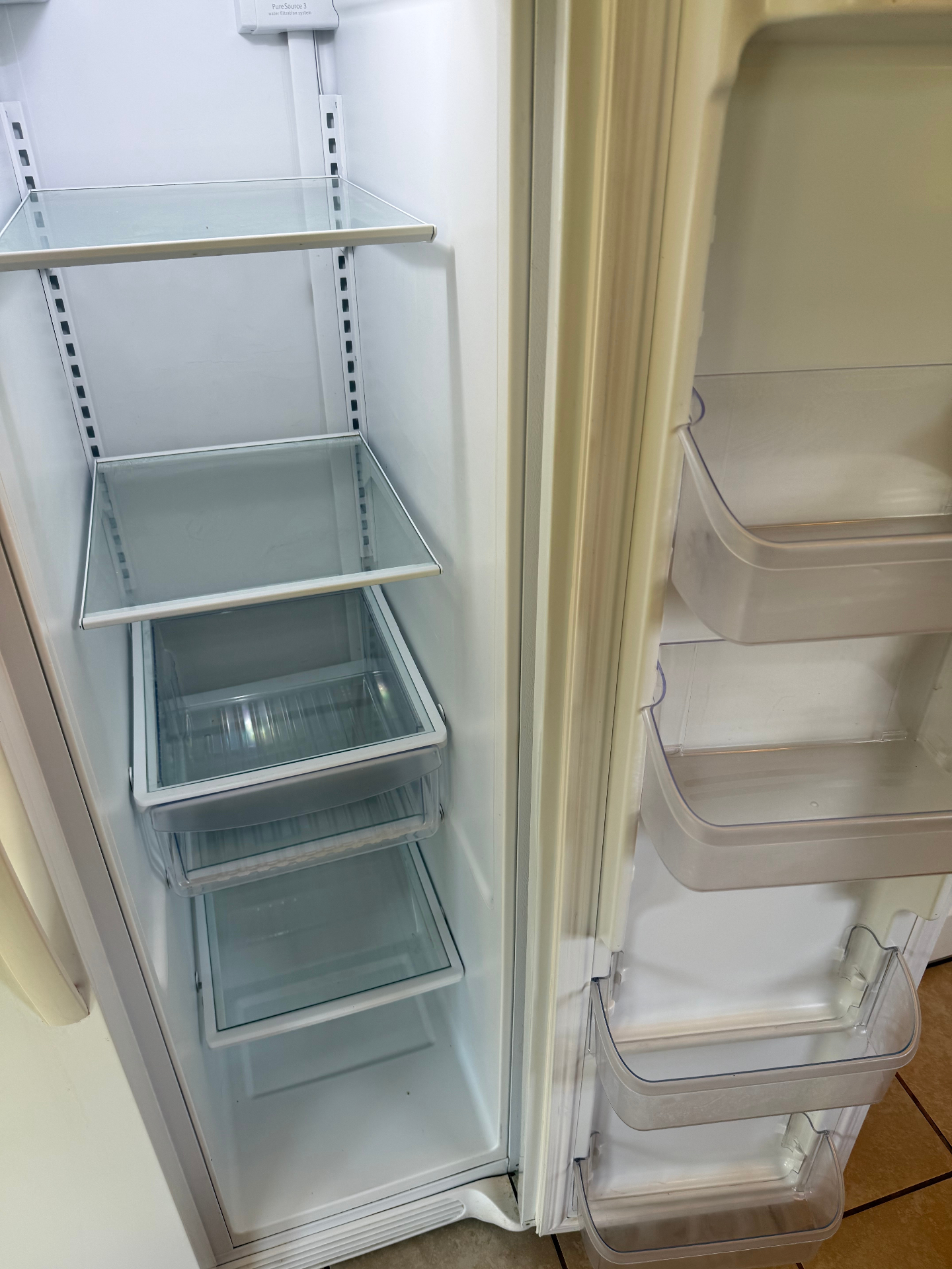 The same refrigerator emptied, wiped down, and streak-free