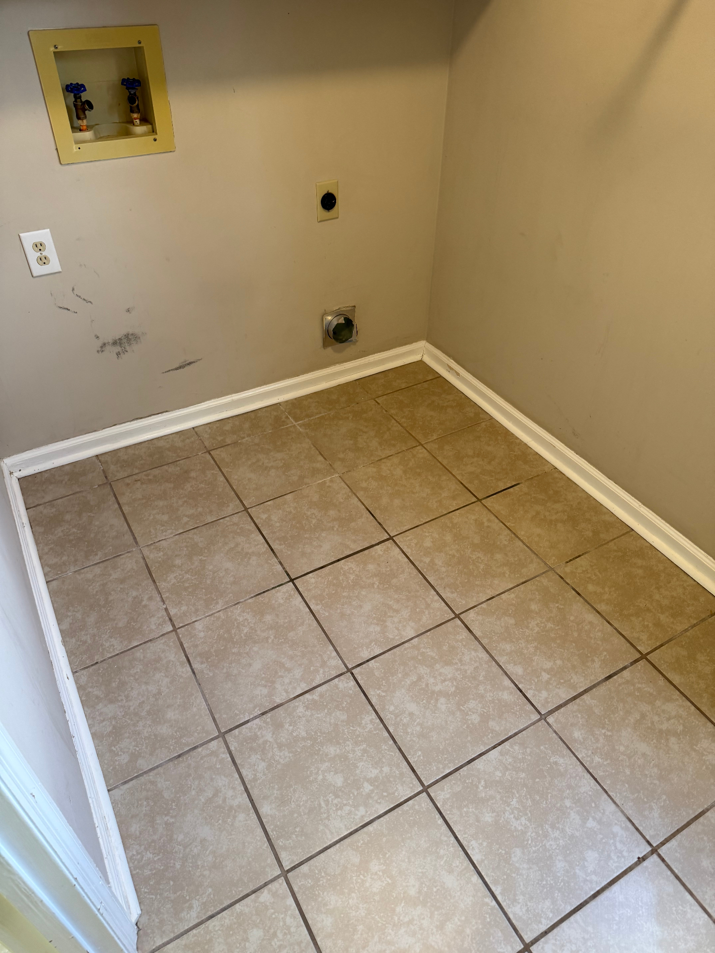 The same laundry room with clean tile, wiped baseboards, and clear walls